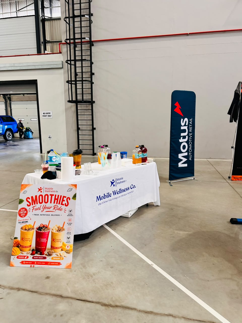 Mobile Wellness Co. smoothie bike station setup at a Motus corporate wellness activation